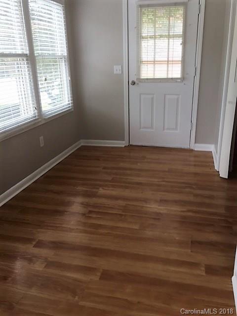 977 Soco Road Maggie Valley, NC 28751 - Photo 11 of 12 an empty room with wooden floor and windows