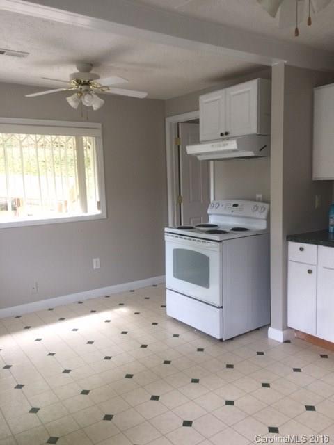 977 Soco Road Maggie Valley, NC 28751 - Photo 7 of 12 a kitchen with cabinets appliances and a window