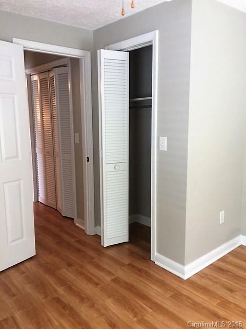 977 Soco Road Maggie Valley, NC 28751 - Photo 9 of 12 an empty room with wooden floor and closet