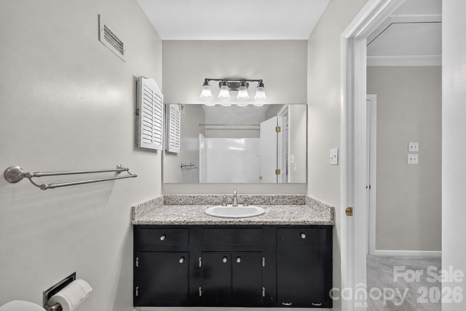 185 Riverview Terrace Clover, SC 29710 - Photo 11 of 35 a bathroom with a granite countertop sink a mirror and a vanity