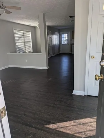 a view of a hallway with wooden floors and stairs