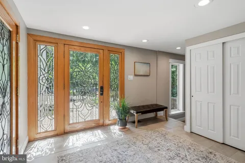 a view of an entryway with wooden floor and windows