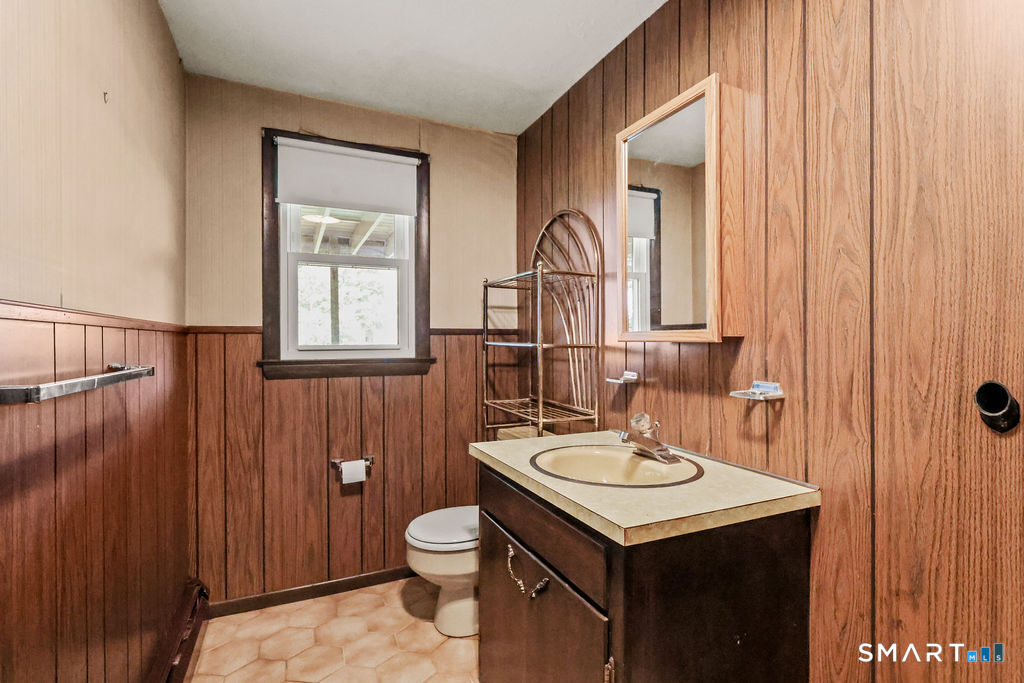 142 Wolcott Hill Road Wethersfield, CT 06109 - Photo 24 of 29 a bathroom with a sink a toilet and mirror