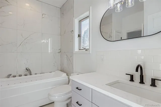 a bedroom with a bed and a large mirror