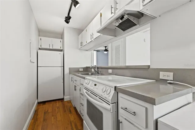a kitchen with a sink a refrigerator and a sink