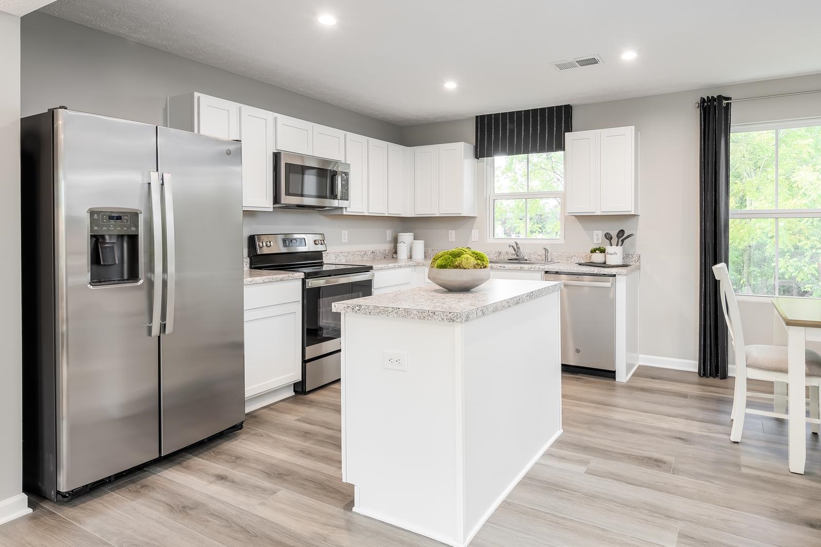 3388 Marble Loop Harrisonburg, VA 22801 - Photo 2 of 9 a kitchen with stainless steel appliances a refrigerator a sink a stove a table and chairs
