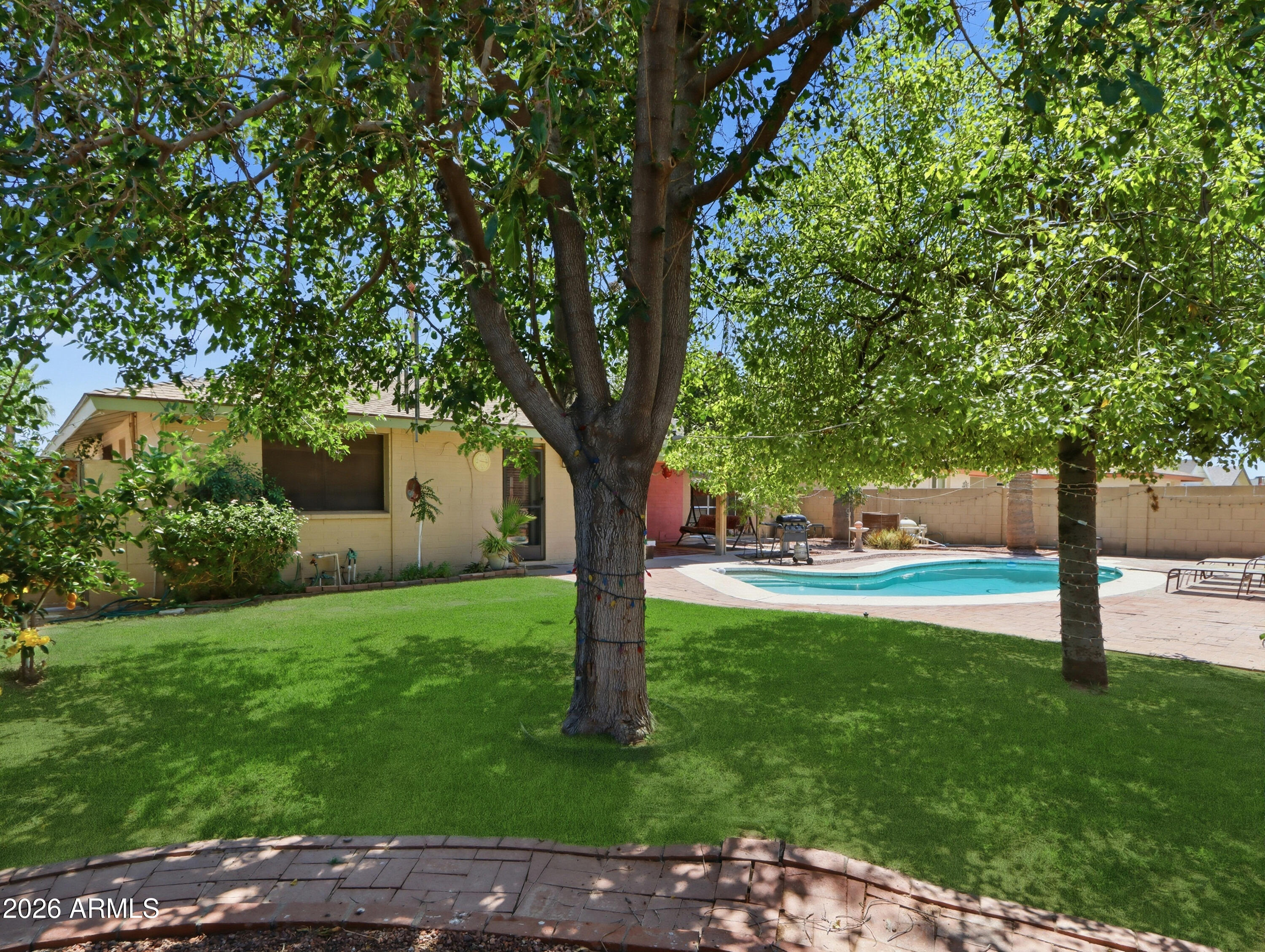 450 Cascada Road Litchfield Park, AZ 85340 - Photo 34 of 40 a view of a backyard with large trees