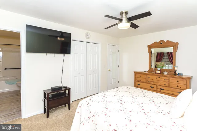 a bed room with a bed and a television