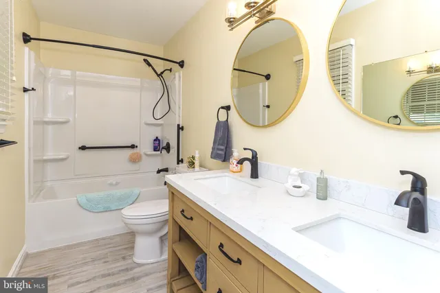 a bathroom with a sink a mirror a bathtub and a shower