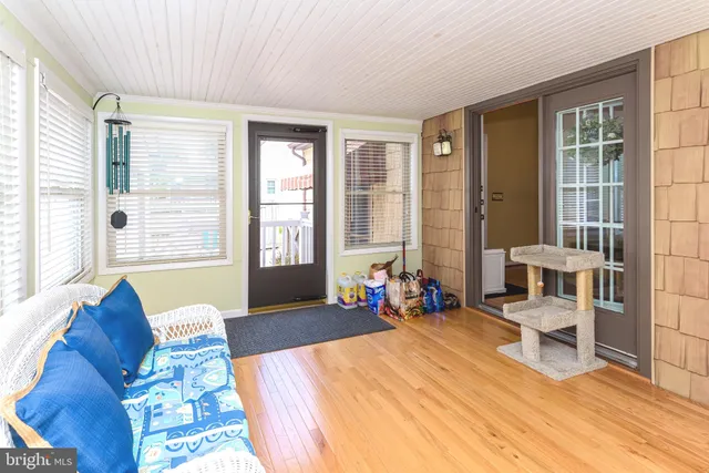 a bedroom with furniture and large windows
