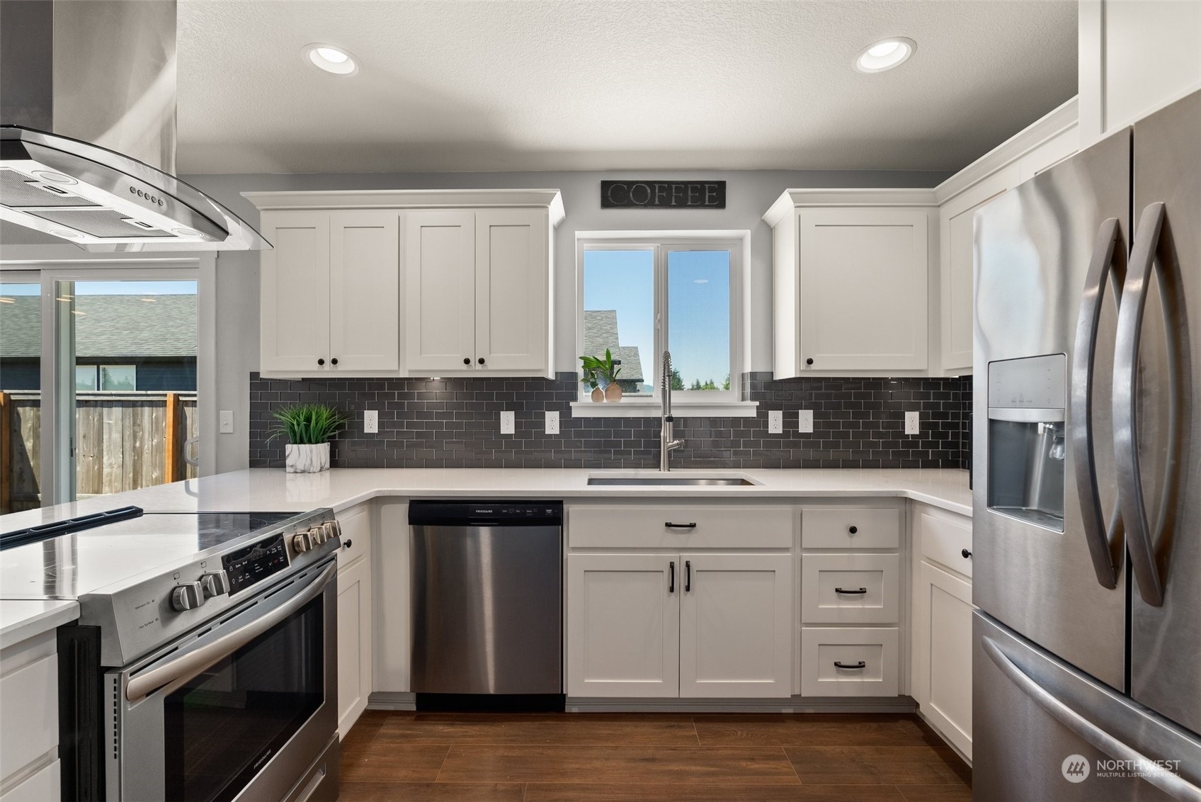 702 Roundtree Boulevard Winlock, WA 98596 - Photo 8 of 35 a kitchen with stainless steel appliances granite countertop a stove a sink and a refrigerator