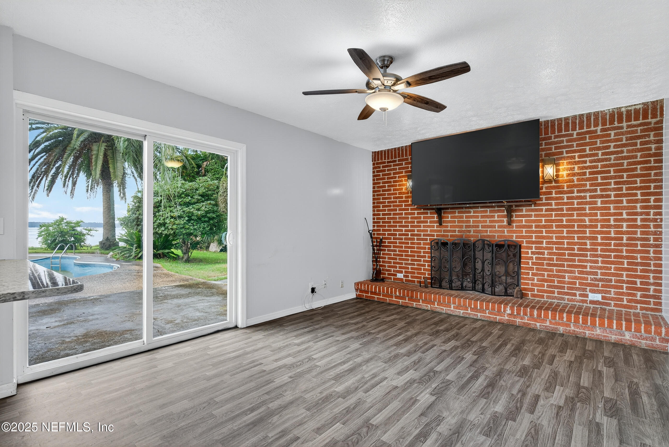 4429 Cedar Road Orange Park, FL 32065 - Photo 15 of 50 a view of empty room with fireplace and wooden floor