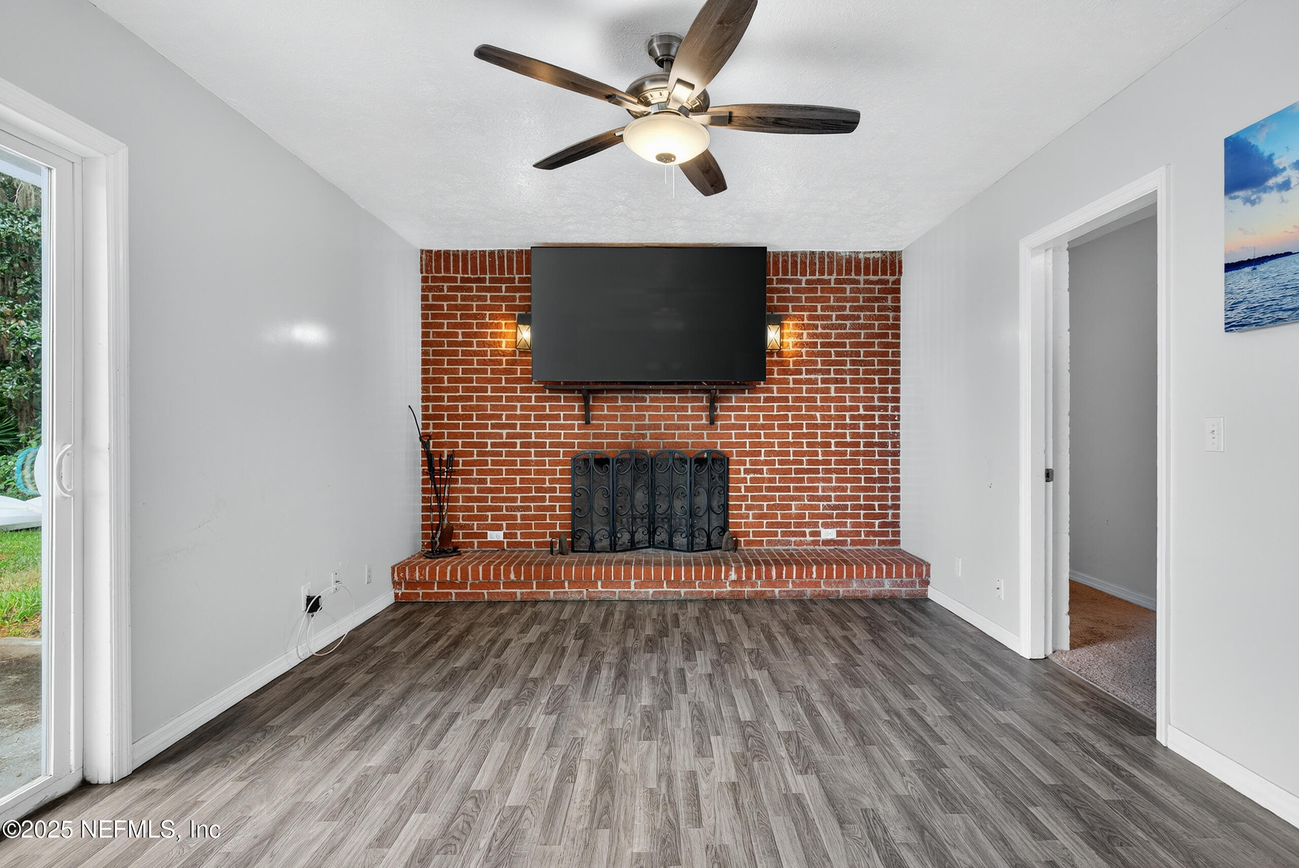 4429 Cedar Road Orange Park, FL 32065 - Photo 16 of 50 a view of an empty room with a fireplace and a window
