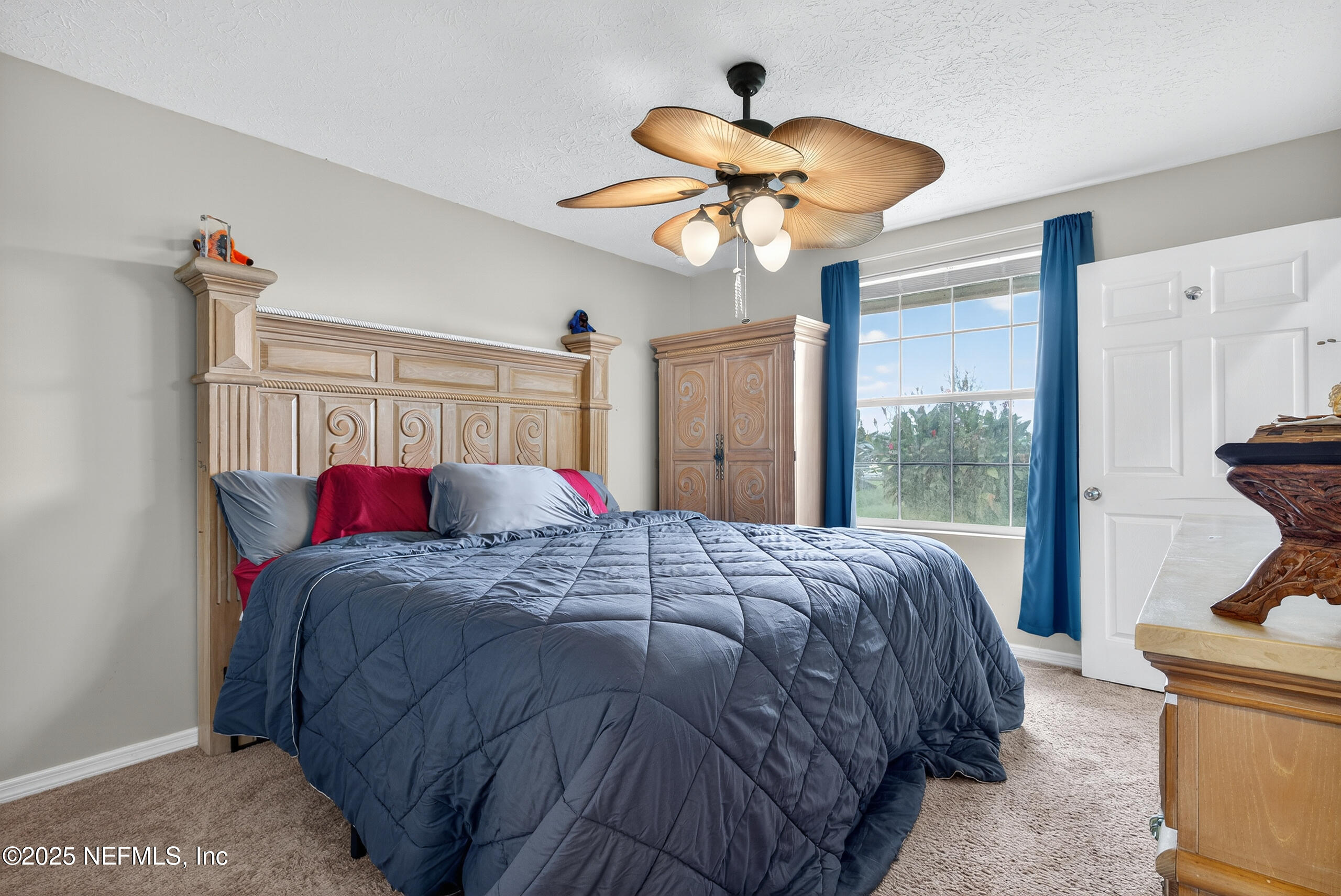4429 Cedar Road Orange Park, FL 32065 - Photo 23 of 50 a bedroom with a bed and a chandelier
