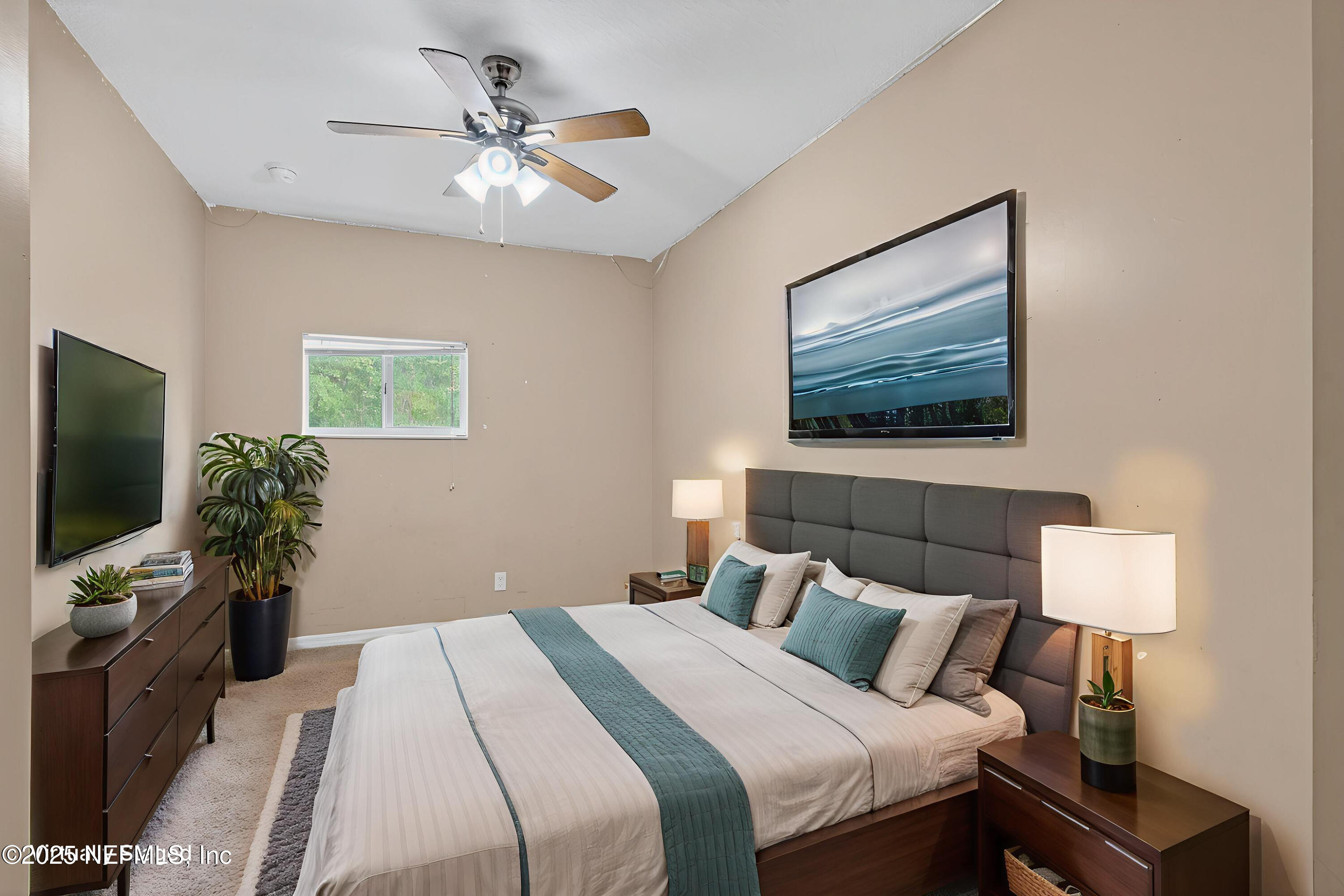 4429 Cedar Road Orange Park, FL 32065 - Photo 31 of 50 a bedroom with a bed and a flat screen tv