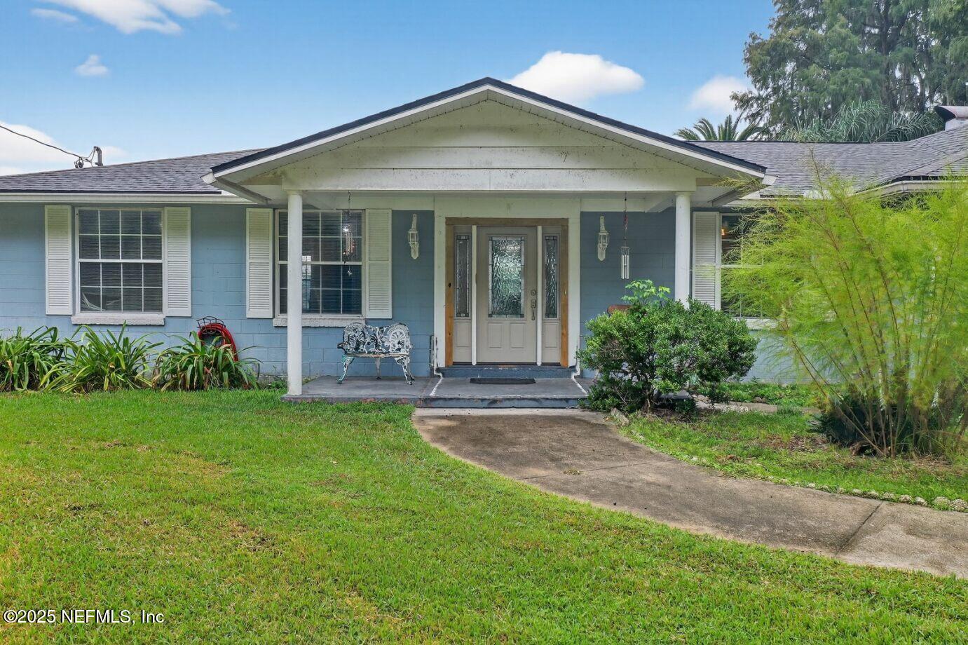 4429 Cedar Road Orange Park, FL 32065 - Photo 48 of 50 a front view of a house with a garden and porch