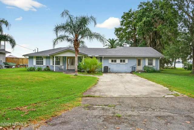 a view of house that has a yard
