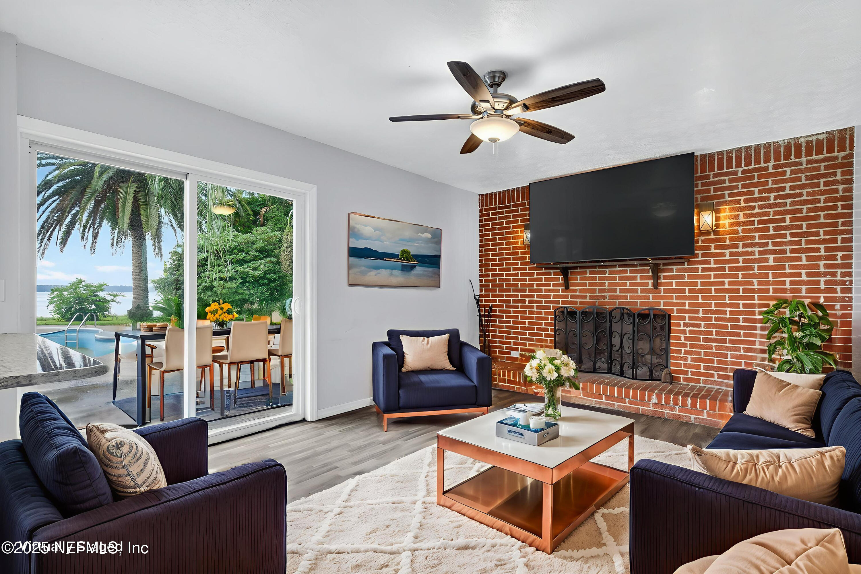 4429 Cedar Road Orange Park, FL 32065 - Photo 8 of 50 a living room with furniture a fireplace a flat screen tv and a large window