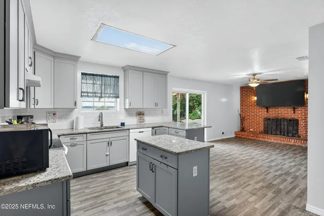 a kitchen with a sink cabinets and window