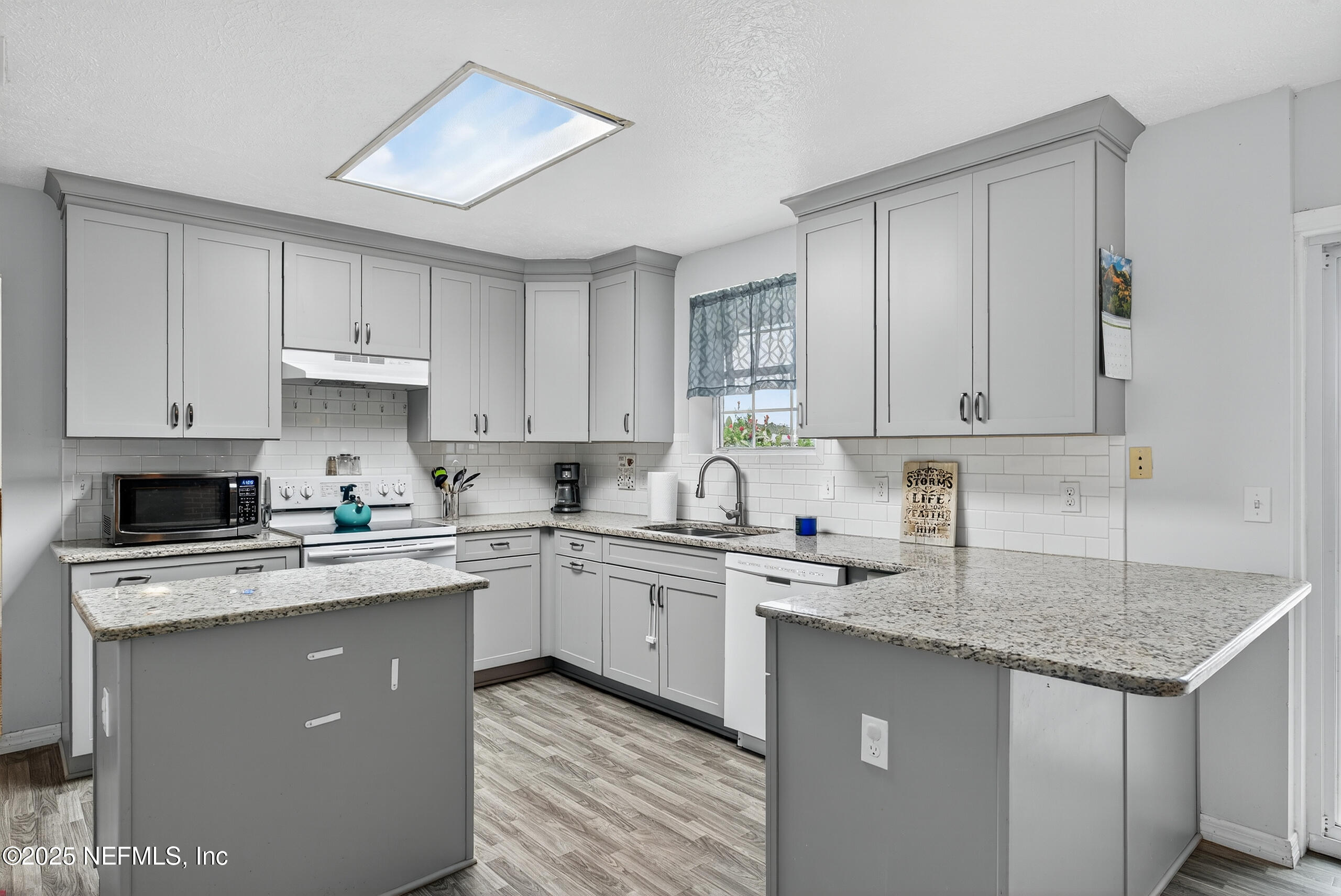 4429 Cedar Road Orange Park, FL 32065 - Photo 10 of 50 a kitchen with stainless steel appliances granite countertop a sink stove cabinets and refrigerator