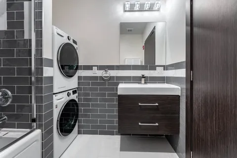 a bathroom with a sink and a washing machine