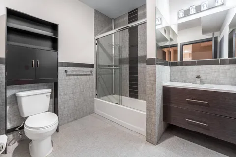 a bathroom with a toilet a sink and bathtub