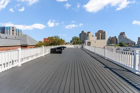 a view of a balcony with wooden floor