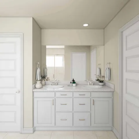 a en suite bathroom with double sink and a mirror