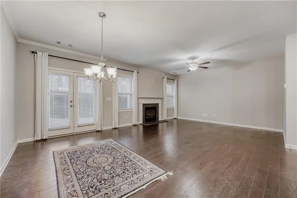 a view of a livingroom with a ceiling fan hardwood floor and a ceiling fan