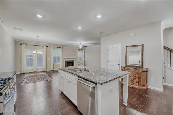 a kitchen with a stove a sink and a refrigerator