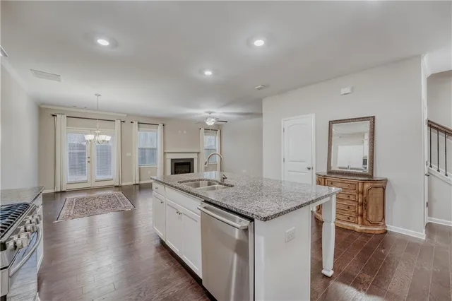 a kitchen with a stove a sink and a refrigerator