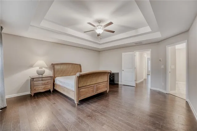 a spacious bedroom with a bed and a chandelier