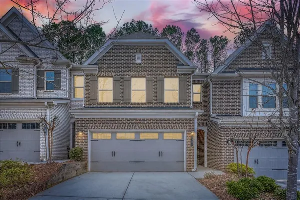 a front view of a house with a garden