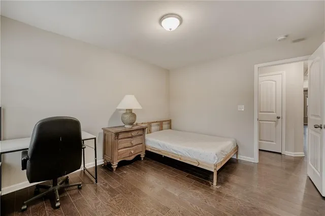 a bedroom with a bed and a chair