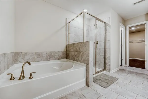 a bathroom with a bathtub and a shower