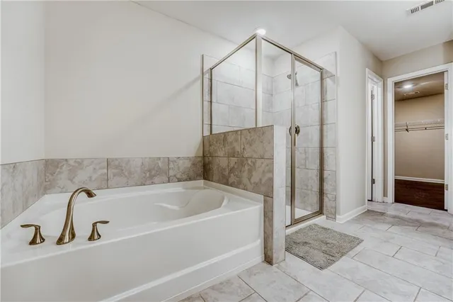 a bathroom with a bathtub and a shower