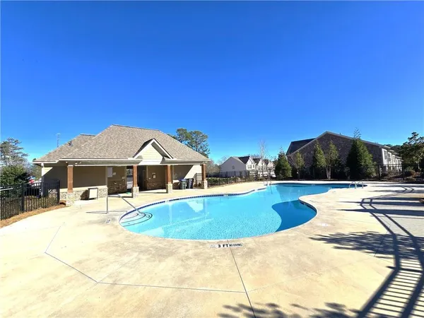 a view of a swimming pool with a lounge chair
