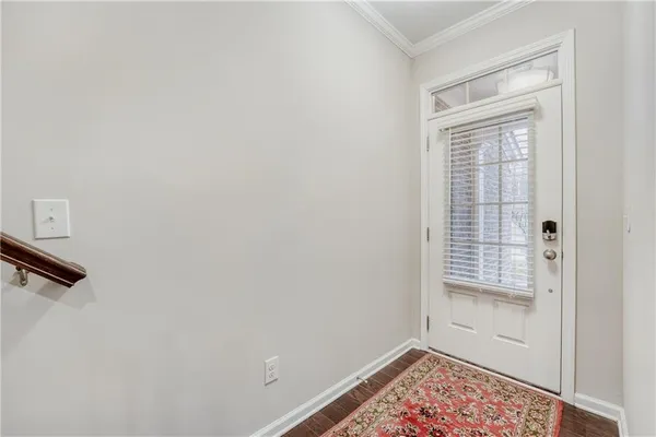 a view of an empty room with closet and a window