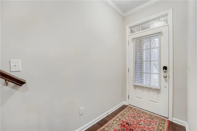a view of an empty room with closet and a window
