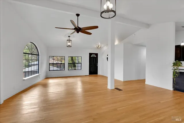 wooden floor in an empty room with a window