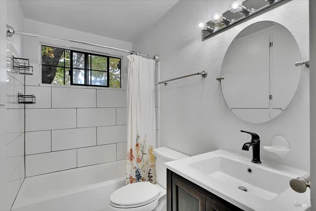 a bathroom with a bathtub a sink and a shower