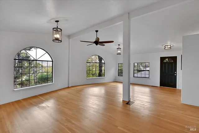 wooden floor in an empty room with a window