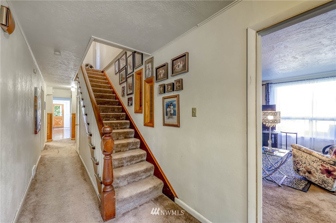 2928 Stewart Road Bremerton, WA 98310 - Photo 22 of 40 a view of a hallway with stairs and furniture
