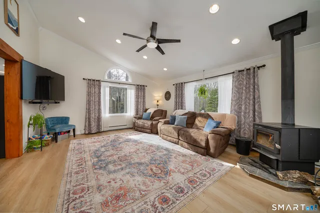 a living room with furniture flat screen tv and a fireplace