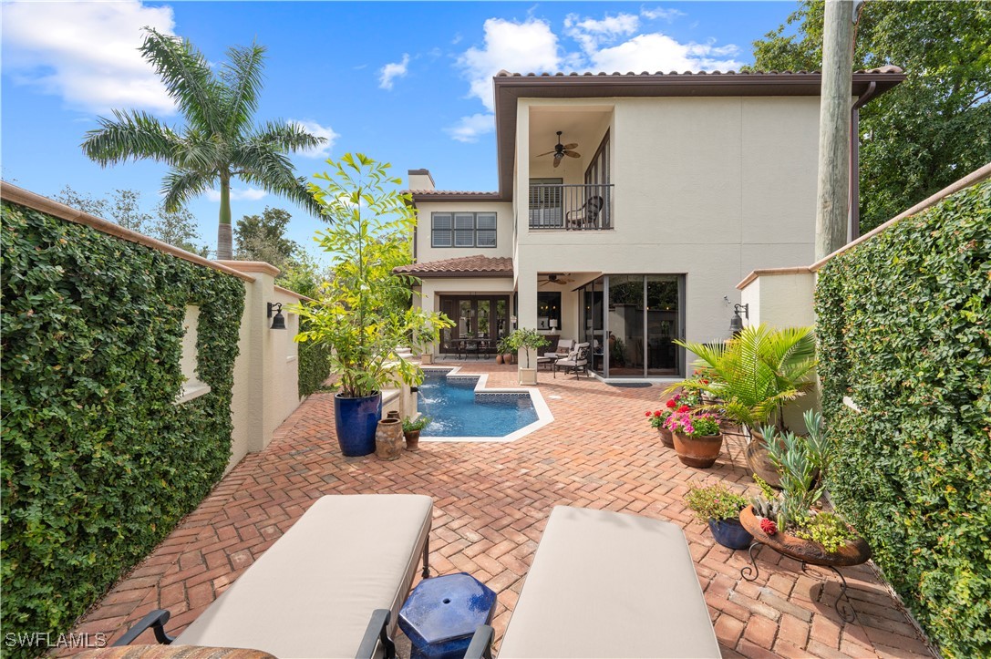 1751 Marlyn Road Fort Myers, FL 33901 - Photo 27 of 49 a view of a house with potted plants and a fountain