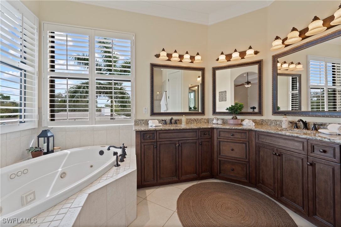 1751 Marlyn Road Fort Myers, FL 33901 - Photo 38 of 49 a spacious bathroom with a tub sink and mirror