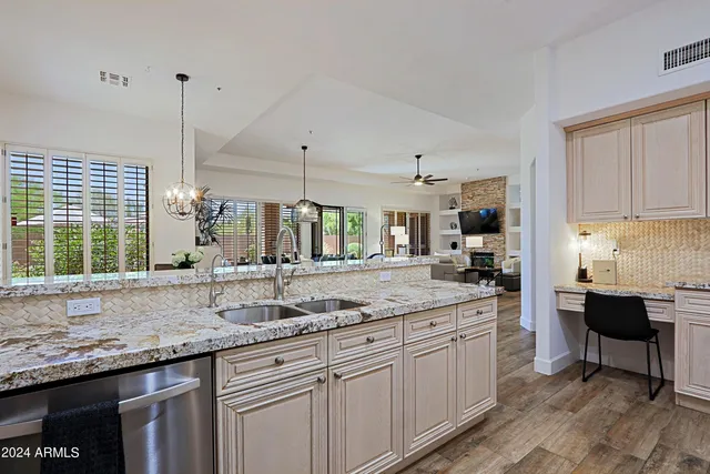a bedroom with a bed a chair and a large window