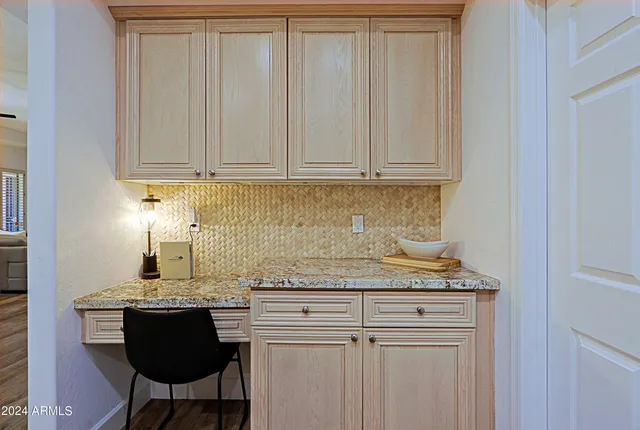 a bathroom with a granite countertop sink mirror vanity and toilet
