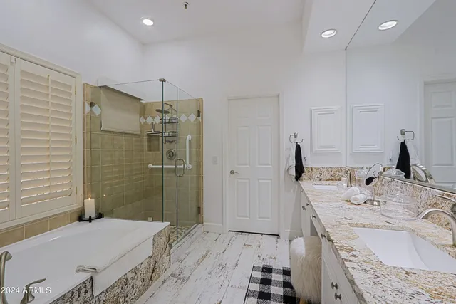 a bathroom with a granite countertop sink toilet mirror and shower