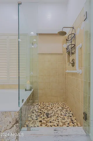 a view of a patio with table and chairs under an umbrella